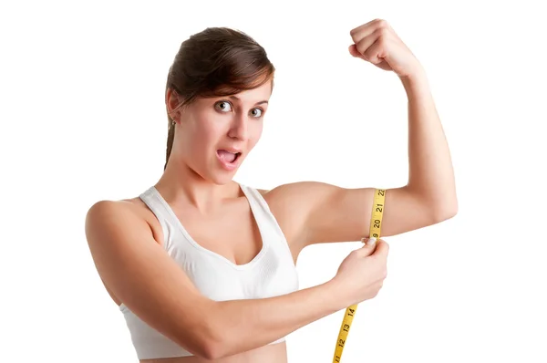 Chockad kvinna mäta sin biceps Stockbild
