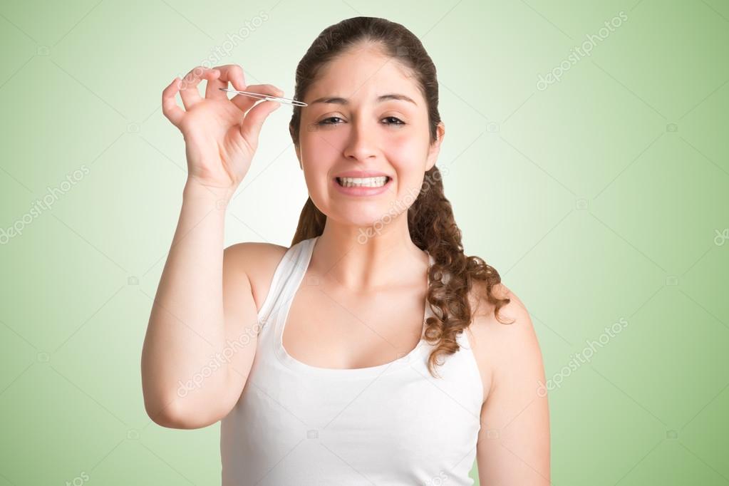 Woman Plucking Eyebrows