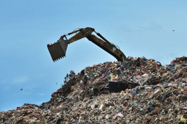 excavator works on the landfill clipart