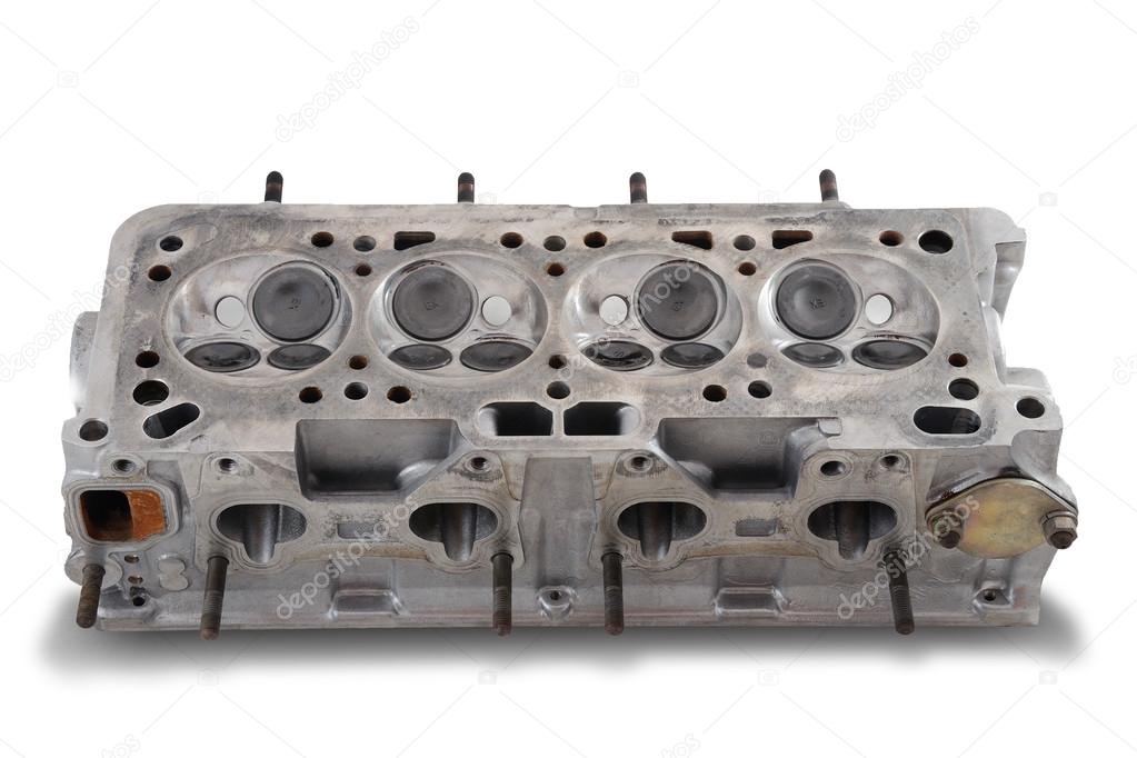 Four cylinder engine head on white