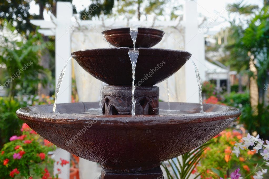 stone fountain with water fall decoration