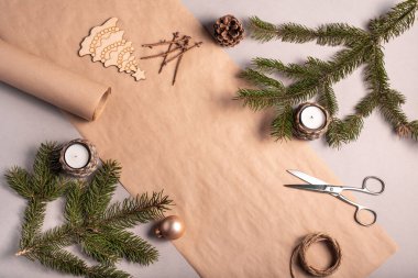 Noel ve yeni yıl hediyelerini çevre dostu malzemelerle paketlemek: Kraft kağıdı, canlı köknar dalları, koni, sicim. Model, doğal dekor, el yapımı, düz yatak etiketleri..