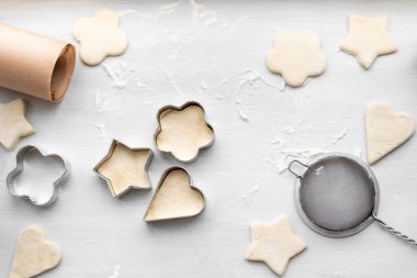 Kalp, yıldız, bulut ve çiçek şeklinde zencefilli kurabiye pişirmenin en güzel manzarası. Noel ve Yeni Yıl konsepti, kış köylüleri için şenlikli hazırlıklar.