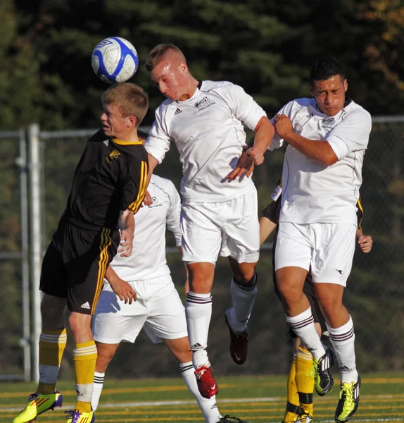 Canada soccer three players jump head ball — Stock Photo, Image