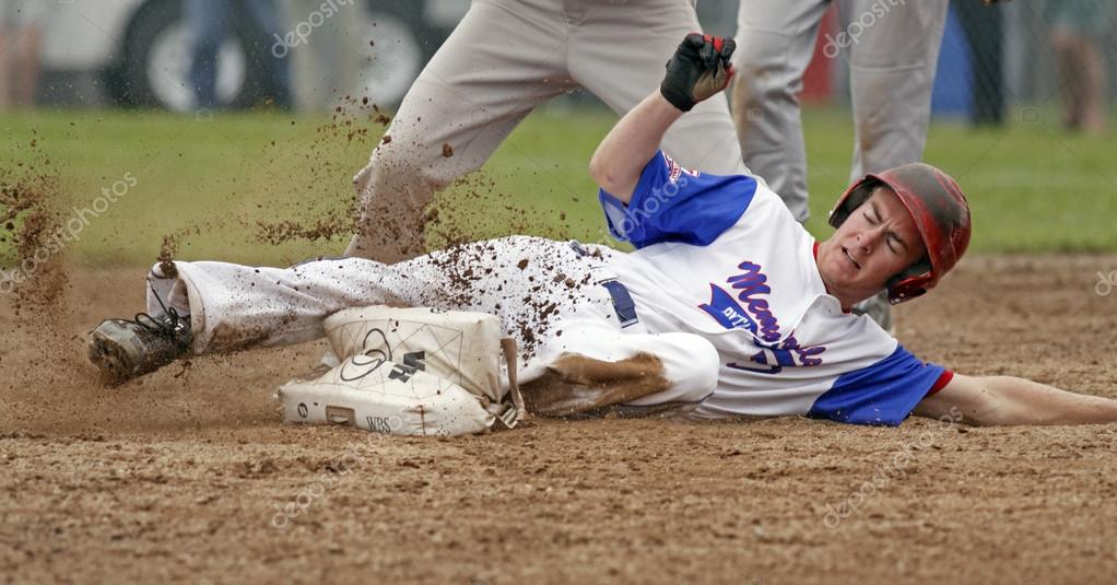 Fastpitch softball men player slide Stock Editorial Photo
