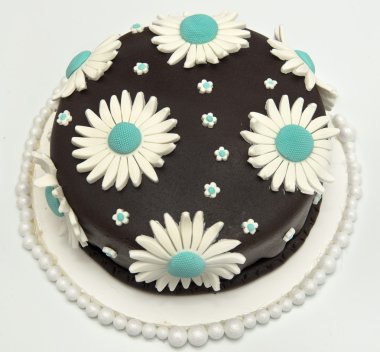 Delicious chocolate cake decorated with daisies clipart