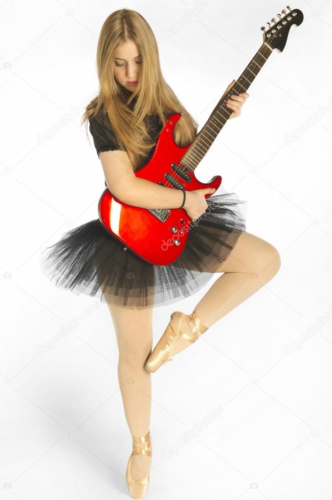 Young ballerina in tutu with electrical guitar