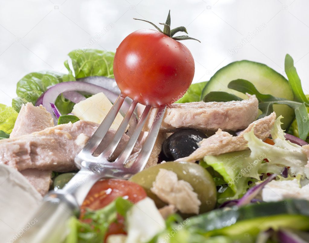 Salad with fork and tomato