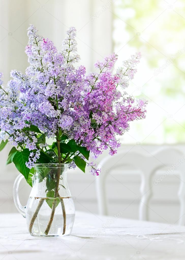 bunch lilac flowers in vase on table