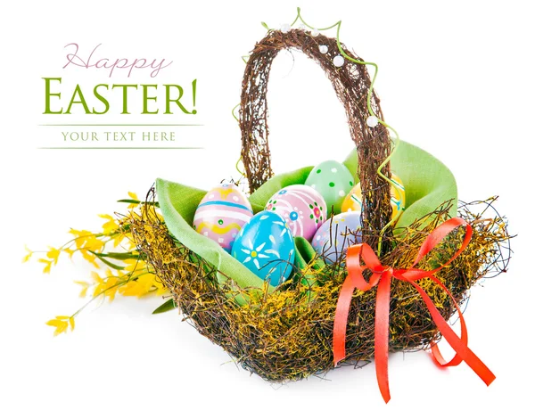 Easter eggs in basket with spring flowers — Stock Photo, Image