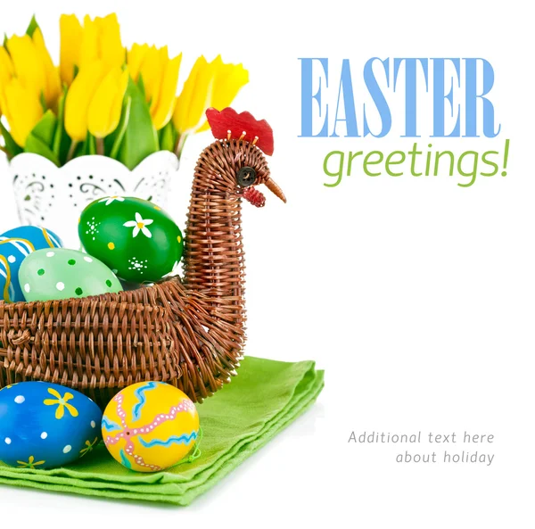 Easter eggs in basket with flowers — Stock Photo, Image