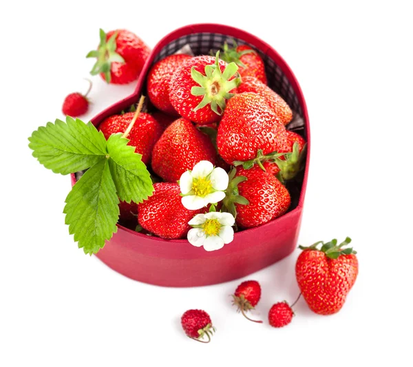 Fresh strawberries in box as heart with green leaf — Stock Photo, Image