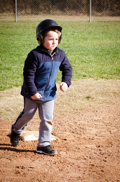 拠点 t ボールの練習で走っている少年 — ストック写真