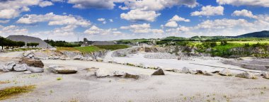 taş ocağı bulutlu mavi gökyüzü altında çalışma