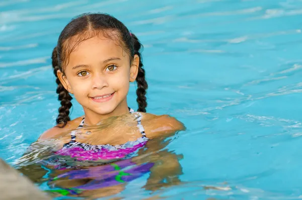 Portrait of happy pretty mixed race child by side of pool during summer — Stock Photo, Image