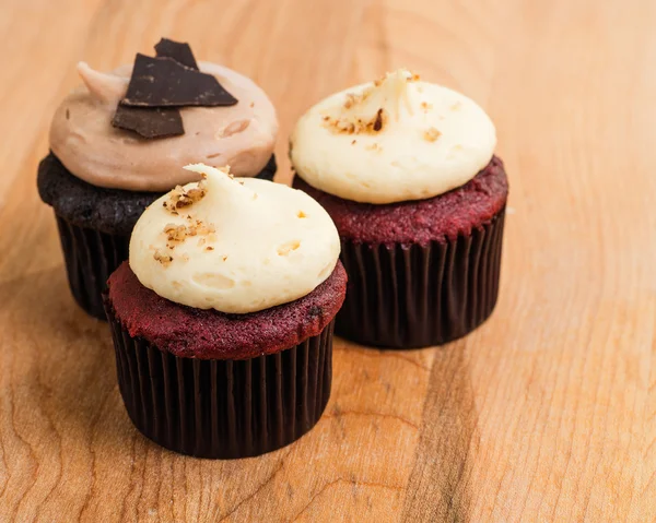 Trio of chocolate and red velvet mini cupcakes with cream cheese frosting