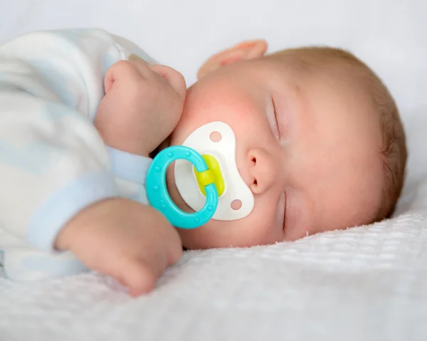 Infant baby boy sleeping peacefully with pacifier — Stock Photo, Image