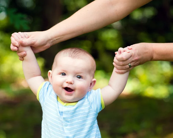 Happy baby boy learning to walk on grass outdoors — Stock Photo, Image