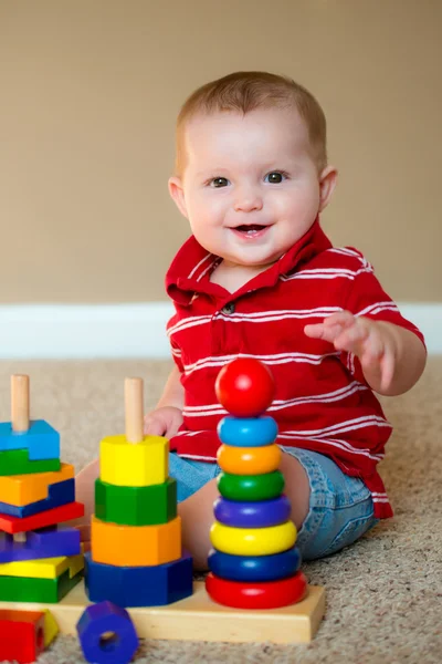 Baby boy playing with stacking learning toy — Stock Photo, Image