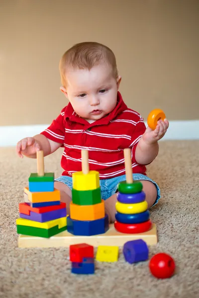 Baby boy playing with stacking learning toy — Stock Photo, Image