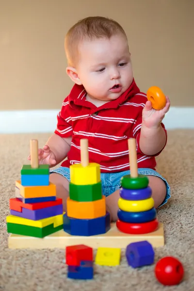 Baby boy playing with stacking learning toy — Stock Photo, Image