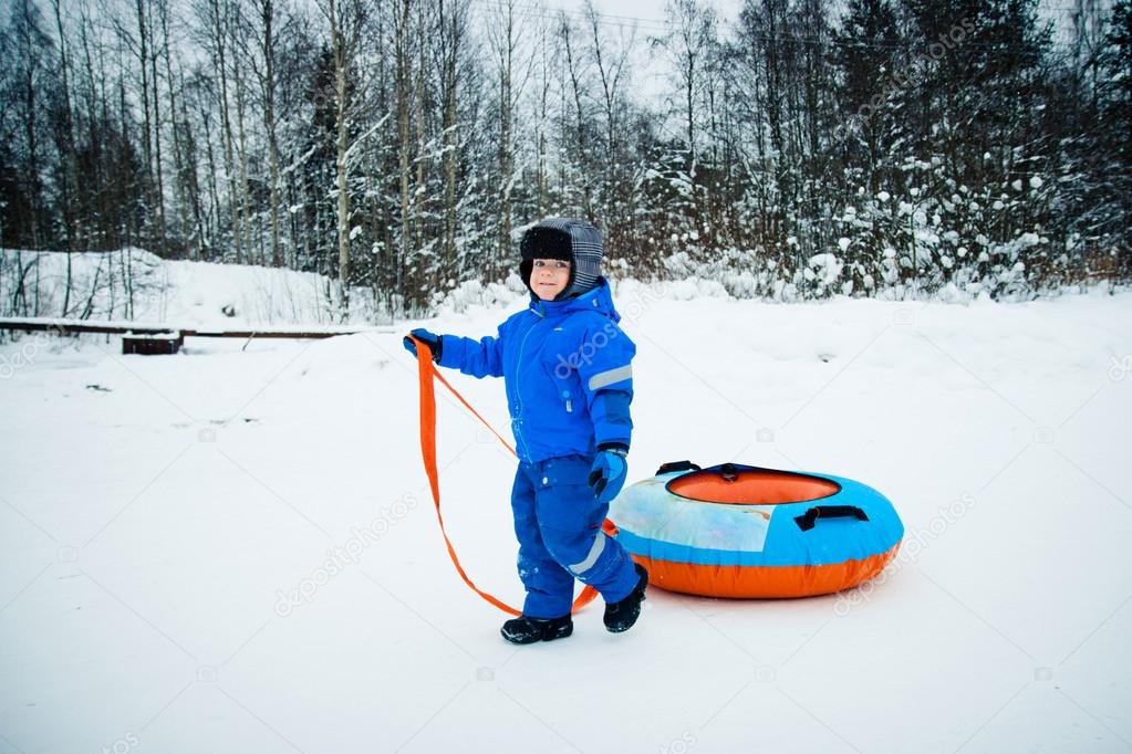 A boy on a snow tube