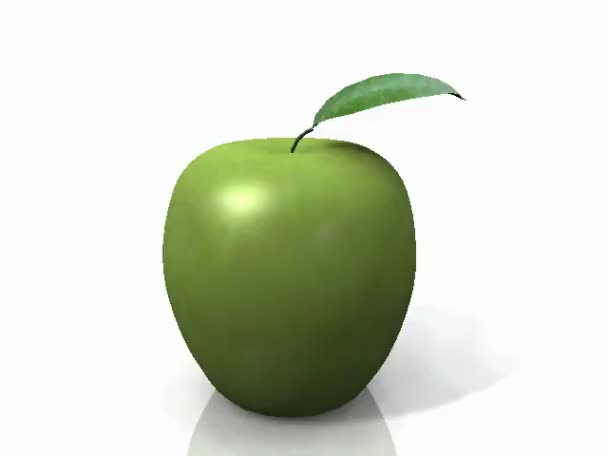 Green apple turning on itself on a white background — Stock Video