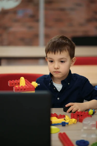 Malý chlapec baví s budováním a tvorbou robota. — Stock fotografie