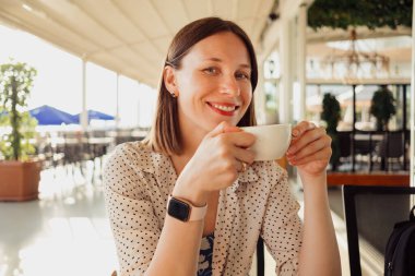 Tranquil day serene woman relaxing drinking coffee enjoying her day on summer travel holidays.