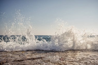 Morning sea shore with splashing waves background and sky on the horison.