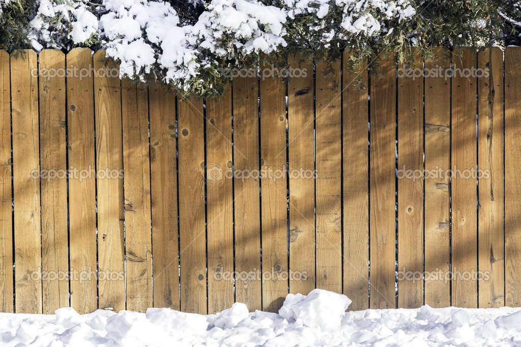 Wooden fence with snow