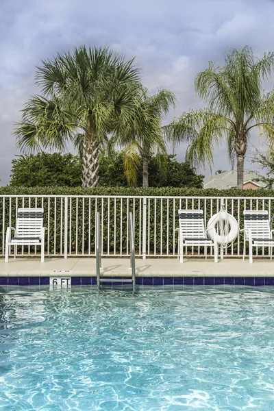 Swimming pool against palms in — Stock Photo, Image