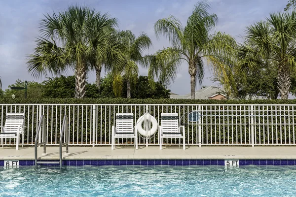 Swimming pool against palms in — Stock Photo, Image