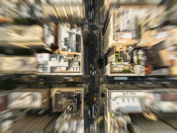 Aerial top down view of New York downtown buildings and street intersection. Manhattan cityscape infrastructure with yellow cabs. Motion blur effect applied