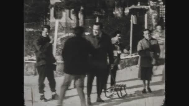 DOLOMITES, ITALY JANUARY 1964: People having fun in the snow in 60s — Stock Footage Dolomites Italy January 1964 People Having Fun Snow 60S Video Clip