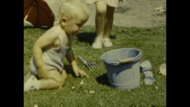 Paris, France july 1958: Babies summer family memories outdoor garden in 50s