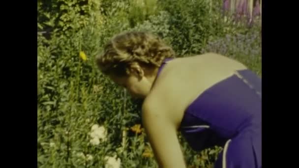 Paris France July 1958 Woman Collects Flowers Garden 50S — стоковое видео