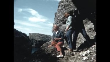 Normandy, France May 1964: Normandy rocky coast people excursion scene in 60s