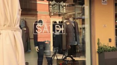 Rovigo, Italy 29 july 2022: Sales showcase shop detail. Saldi means sales in English.
