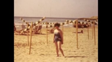 Barcelona, Spain june 1958: People at vacation on beach scene in 50s