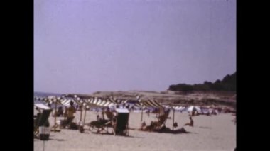 Barcelona, Spain june 1958: People at vacation on beach scene in 50s