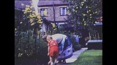 Barcelona, Spain june 1958: Mom and child garden family memories scene in 50s