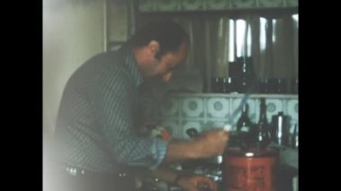 Liguria, Itally August 1965: Happy people kitchen prepare food scene in 60s