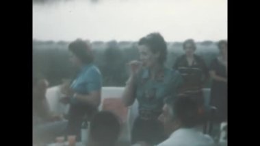 Liguria, Itally August 1965: Family people garden table scene in 60s