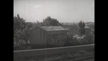 Catanzaro, Italy augUSt 1962: View from car road signboard old houses vehicles in 60s