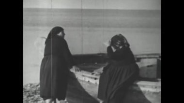 Catanzaro, Italy august 1962: People beach vacation old movie scene in 60s