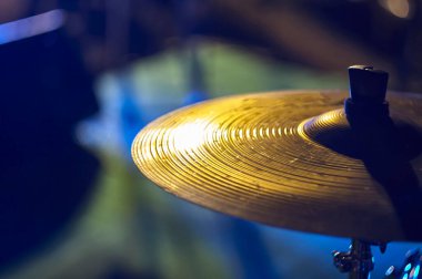 Detail of the plate of a drum set of a rock band. Shooting with soft and colorful lights