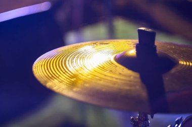 Detail of the plate of a drum set of a rock band. Shooting with soft and colorful lights