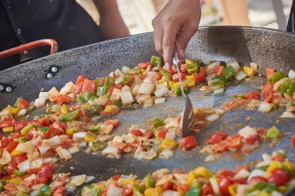 Frying pan full of vegetables that cook for the preparation of the sauce: An example of how you can cook vegetables to make a tasty sauce.