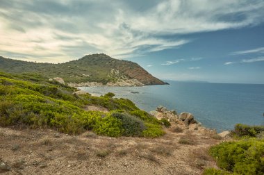 Beautiful Mediterranean bay typical of the southern coast of Sardinia in Italy during the sunset.